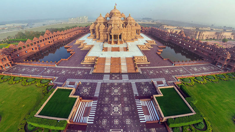 Akshardham temple reflecting in the water at sunset, New Delhi, India